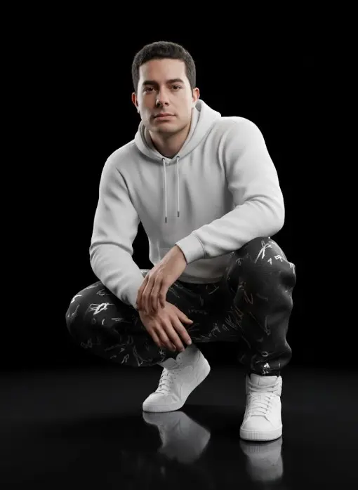 con mi foto Genera una imagen en calidad 16K de estilo hiperrealista con etalonaje cinematográfico tipo película IMAX. Crear una representación CGI ultra realista de un hombre real en posición de cuclillas, con la mirada serena e introspectiva dirigida al frente. El sujeto debe conservar el 100% de su fisionomía auténtica: rasgos faciales, proporciones, textura de piel, expresión y volumen corporal, replicados con precisión fotográfica a partir de la foto de referencia, integrado de forma perfecta con la iluminación y las condiciones del entorno. 
El hombre viste una sudadera blanca y pantalones negros holgados con sutiles patrones abstractos en tonos plateado. Unas zapatillas blancas estilo Puma. Las telas deben exhibir textura textil nítida, microfibras visibles, variaciones naturales de sombra y zonas de compresión propias de la postura. Calza zapatillas blancas de caña alta, modeladas con precisión: costuras microscópicas, suelas con acabado de caucho, ligeros brillos especulares y superficies tratadas con comportamiento físico real de la luz. 
La escena se desarrolla sobre un vacío negro absoluto, con un suelo oscuro reflectante de acabado brillante que proyecta un reflejo limpio y definido del sujeto. El entorno debe emitir sensación de inmensidad y silencio visual, empleando iluminación suave y direccional de calidad cinematográfica, con contrastes medidos, negros profundos y reflejos controlados para resaltar volúmenes, relieves y micro texturas. La piel del sujeto debe mantener apariencia humana auténtica: poros visibles, matices reales, imperfecciones naturales, micro brillos y profundidad óptica sin ningún rastro de suavizado digital.
El resultado debe ser completamente indistinguible de una fotografía real, con renderizado físico de la luz, sombras coherentes y precisión extrema en todos los materiales: textiles, superficies metálicas, brillo especular y transiciones tonales.