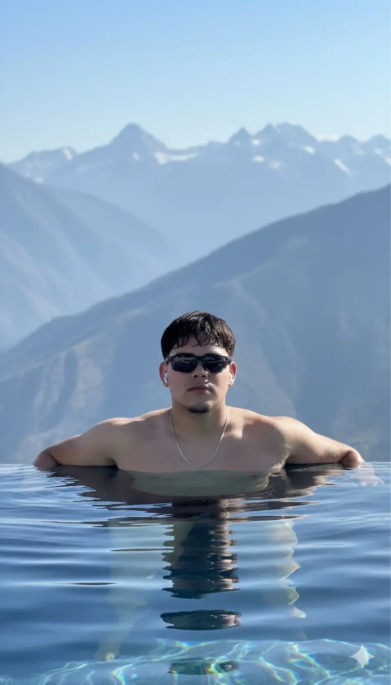 Eres un fotógrafo profesional y realizarás este retrato cinematográfico usando de modelo al sujeto de la foto.
Fotografía de estilo de vida cinematográfico usando de modelo al chico de la foto, una toma de alta costura y aspiracional de un joven guapo y atlético. Lleva gafas deportivas y una fina cadena plateada, relajándose al borde de una lujosa piscina infinita, sumergida hasta el pecho con el pelo algo mojado. El fondo son montañas nevadas moderno vasto, extenso y brumoso. La iluminación es brillante, luz solar directa, proyecta reflejos nítidos en su piel y crea ondas en el agua azul oscura. El estado de ánimo general es de lujo, éxito y tranquilidad de alta gama. Detalles fotorrealistas con nítidos sobre el tema.
Resolución de 8k, hiperrealista, FHD.
--Ar 9: 16 --estilo crudo --v 6,0