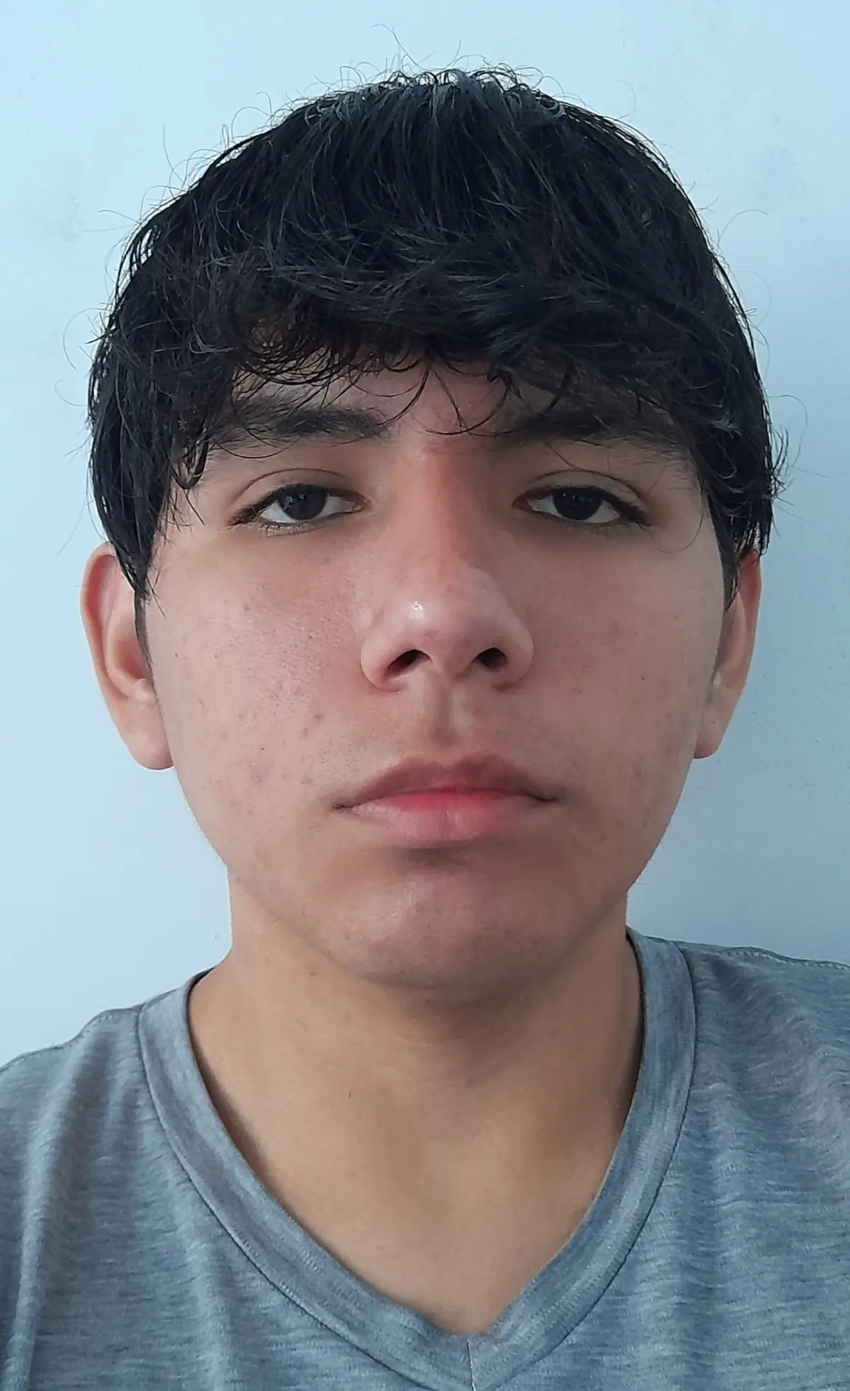 Portrait-orientation, medium-long shot of Subject[Person in the Image] standing in torrential rain at night, arms flung wide with open palms, spine arched and chest lifted, head tipped back toward the downpour; low-angle 3/4 profile (~20° up). Composition: Subject centered with a slight left bias, generous headroom and surrounding negative space, diagonal rain streaks slashing across the frame as leading lines, symmetrical arm span forming strong triangular shapes, clean featureless background; crop near shins. Camera: Canon EOS 5D Mark IV (full-frame) + 50 mm, f/2.8, 1/60 s, ISO 800, white balance 3200 K; static/tripod. Lighting: single warm backlight high at 3/4 back-right creating a bright rim on jaw/arms and lighting the rain, minimal/no fill. Environment: exterior night in heavy rain with a dark background and backlit spray. Color grade: cinematic warm amber with deep blacks, moderate saturation, slightly warm temperature. Mood: cathartic, exultant, freedom. Aspect ratio 2:3. Post: S-curve contrast, clarity/micro-contrast to emphasize rain streaks, subtle vignette, mild noise reduction. Negative prompts: watermark, text artifacts, banding, oversoften skin, extra limbs, warping, blown highlights, HDR halos, plastic look.